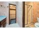 Bathroom with shower, tile floor and floral wallpaper at 103 Nob Hl, Peachtree City, GA 30269