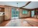 Dining area features wood accents, tiled flooring, and sliding glass doors to a deck with wooded views at 103 Nob Hl, Peachtree City, GA 30269