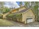 A shot of the side of this two story home showing the garage entrance at 103 Nob Hl, Peachtree City, GA 30269