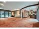 Spacious living room with carpet flooring and large windows showcasing the outdoor landscape at 103 Nob Hl, Peachtree City, GA 30269