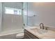 Bathroom featuring a tub/shower with a herringbone tile surround and a vanity with white marble countertop at 158 Hemphill School Rd, Atlanta, GA 30331
