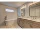 Elegant bathroom showcasing a freestanding tub, double vanity with modern fixtures, and stylish tile accents at 158 Hemphill School Rd, Atlanta, GA 30331