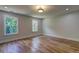 Well-lit bedroom with hardwood floors and large windows offering a view of the outdoors at 158 Hemphill School Rd, Atlanta, GA 30331