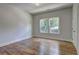 Bright bedroom featuring hardwood floors, white trim, and double windows allowing ample natural light at 158 Hemphill School Rd, Atlanta, GA 30331