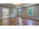 Bedroom with hardwood floors leading to a bathroom; features a large window for natural light at 158 Hemphill School Rd, Atlanta, GA 30331