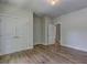 Bedroom with hardwood floors, overhead lighting, and open doorway leading to another room at 158 Hemphill School Rd, Atlanta, GA 30331