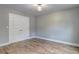 Bedroom featuring hardwood floors and a modern ceiling light fixture, creating a cozy and stylish ambiance at 158 Hemphill School Rd, Atlanta, GA 30331