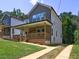 New home boasts a classic porch and driveway, perfect for relaxed living at 158 Hemphill School Rd, Atlanta, GA 30331