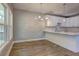 Kitchen with white cabinets, quartz countertop, subway tile backsplash, hardwood floors and chandelier at 158 Hemphill School Rd, Atlanta, GA 30331