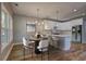 Bright kitchen features white cabinets, stainless appliances, and a dining area with stylish chandelier at 158 Hemphill School Rd, Atlanta, GA 30331