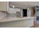 Kitchen with white cabinets, quartz countertop, subway tile backsplash and hardwood floors at 158 Hemphill School Rd, Atlanta, GA 30331