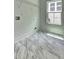 Bright laundry room with white walls, modern gray-toned floors, and a window for natural light at 158 Hemphill School Rd, Atlanta, GA 30331