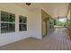 Spacious covered porch with a smooth floor, suitable for creating a comfortable outdoor living space at 158 Hemphill School Rd, Atlanta, GA 30331