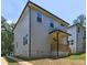 Rear exterior showcases a covered porch and modern siding, set in a landscaped yard at 158 Hemphill School Rd, Atlanta, GA 30331