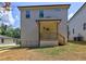 New home with a cozy back porch, set against a backdrop of trees and sky at 158 Hemphill School Rd, Atlanta, GA 30331