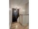 Wooden staircase with modern black accent wall, decorative lighting and light wood railing at 158 Hemphill School Rd, Atlanta, GA 30331