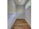 Well-organized walk-in closet with ample shelving and hardwood floors, providing generous storage space and functionality at 158 Hemphill School Rd, Atlanta, GA 30331