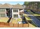 A fenced backyard offers a patio and a fire pit sitting area, providing comfortable outdoor living space at 158 Village Green Ave, Woodstock, GA 30189