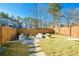 Large backyard featuring a fire pit, ample seating, and lush landscaping at 158 Village Green Ave, Woodstock, GA 30189