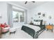 Bright bedroom with stylish decor, plush bedding, a large window with neighborhood views, and comfortable sitting area at 158 Village Green Ave, Woodstock, GA 30189