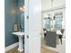 Bright dining room featuring modern chandelier, large windows and open to bathroom with pedestal sink at 158 Village Green Ave, Woodstock, GA 30189