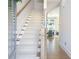 Inviting entryway features hardwood floors and a carpeted staircase at 158 Village Green Ave, Woodstock, GA 30189