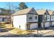 View of townhome exterior with manicured front yard and private garage at 158 Village Green Ave, Woodstock, GA 30189