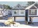 Charming two-story home featuring a clean gray and white exterior with an attached two-car garage at 158 Village Green Ave, Woodstock, GA 30189