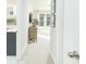 Hallway leads to living area with neutral decor, plush carpet, and natural light at 158 Village Green Ave, Woodstock, GA 30189