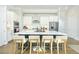 Modern kitchen features a large island, stainless steel appliances, and white cabinets at 158 Village Green Ave, Woodstock, GA 30189