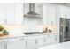 Gourmet kitchen featuring white cabinetry, quartz countertops, and stainless steel appliances at 158 Village Green Ave, Woodstock, GA 30189