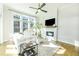 Bright living room with fireplace, modern decor, large windows, and hardwood floors at 158 Village Green Ave, Woodstock, GA 30189
