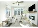 Bright living room with fireplace, large windows, and modern decor at 158 Village Green Ave, Woodstock, GA 30189