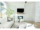 Cozy living room with fireplace, mantle with decor, hardwood floors, and modern furniture at 158 Village Green Ave, Woodstock, GA 30189