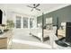 Spacious main bedroom with a four-poster bed, ceiling fan, and large windows at 158 Village Green Ave, Woodstock, GA 30189