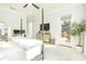 Spacious main bedroom features a four-poster bed, TV, dresser, and access to a private balcony at 158 Village Green Ave, Woodstock, GA 30189