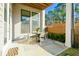 Cozy outdoor patio with table, chairs, and view of the landscaped backyard at 158 Village Green Ave, Woodstock, GA 30189