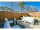 Outdoor patio featuring comfortable seating, a modern fire pit, and stylish landscaping at 158 Village Green Ave, Woodstock, GA 30189