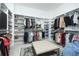 Spacious walk-in closet with custom shelving, plenty of storage, and a comfortable center ottoman at 158 Village Green Ave, Woodstock, GA 30189