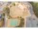 An aerial view of a community park featuring basketball courts, playground, and green space at 214 Cedar Woods Way, Canton, GA 30114