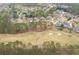 Panoramic aerial view of a residential neighborhood nestled among lush trees and a nearby golf course at 214 Cedar Woods Way, Canton, GA 30114