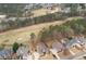 Aerial view showcasing a neighborhood near a golf course, with homes featuring private backyard pools at 214 Cedar Woods Way, Canton, GA 30114