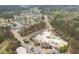 Community aerial view showcases tennis courts, pools, a waterpark, clubhouse, and lush landscaping at 214 Cedar Woods Way, Canton, GA 30114