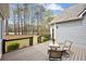 Relaxing back deck area with outdoor seating, perfect for enjoying the peaceful wooded surroundings at 214 Cedar Woods Way, Canton, GA 30114