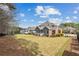 Expansive backyard features a lush lawn with mature trees, offering a private and serene outdoor space at 214 Cedar Woods Way, Canton, GA 30114