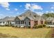 Well-maintained backyard with a screen porch and manicured landscaping, perfect for outdoor relaxation and entertaining at 214 Cedar Woods Way, Canton, GA 30114
