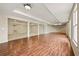 Large basement area featuring wood floors, multiple windows, and structural support beams at 214 Cedar Woods Way, Canton, GA 30114