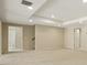 Well-lit basement featuring carpeted floors, recessed lighting, and access to a staircase and doorway at 214 Cedar Woods Way, Canton, GA 30114