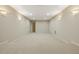 Neutral basement space with carpeted platform and sconce lighting for a cozy, functional area at 214 Cedar Woods Way, Canton, GA 30114
