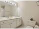 Bright bathroom featuring a white vanity, a large mirror, and modern fixtures at 214 Cedar Woods Way, Canton, GA 30114